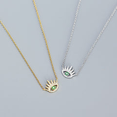 Image of both the rhodium plated and 18k gold plated evil eye cubic zircon necklace in 925 sterling silver