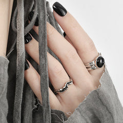 Image of a woman's hand wearing the Black Agate Unisex Adjustable Ring in 925 Sterling Silver in her index finger