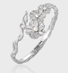 Image of the Floral Shell Pearl Open Bangle in 925 Sterling Silver in a light grey background tilted point of vie