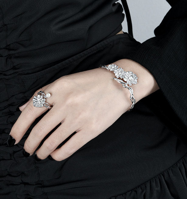 Image of a woman wearing the Floral Shell Pearl Open Bangle in 925 Sterling Silver on her left wrist