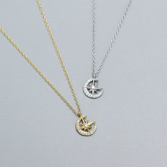 Both rhodium plated and 18k gold plated Crescent Moon & Star Zircon Necklace in 925 Sterling Silver in a grey background