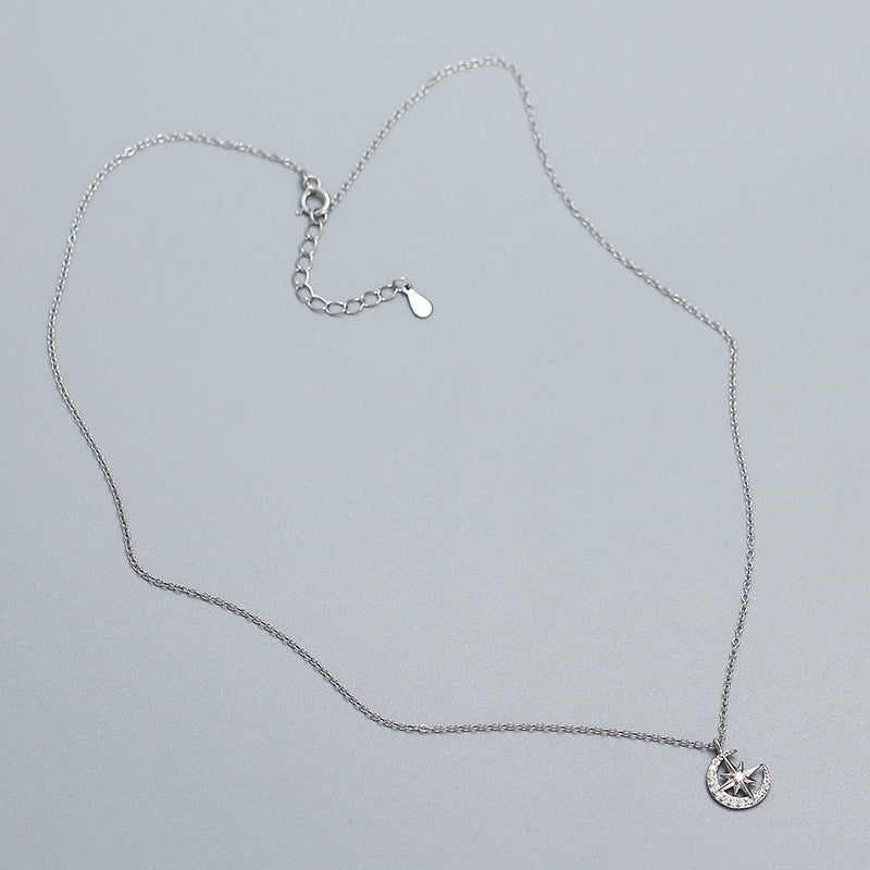 Crescent Moon & Star Zircon Necklace in 925 Sterling Silver plated with rhodium in a grey background