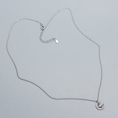 Crescent Moon & Star Zircon Necklace in 925 Sterling Silver plated with rhodium in a grey background