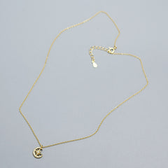 18k gold plated Crescent Moon & Star Zircon Necklace in 925 Sterling Silver in a grey background